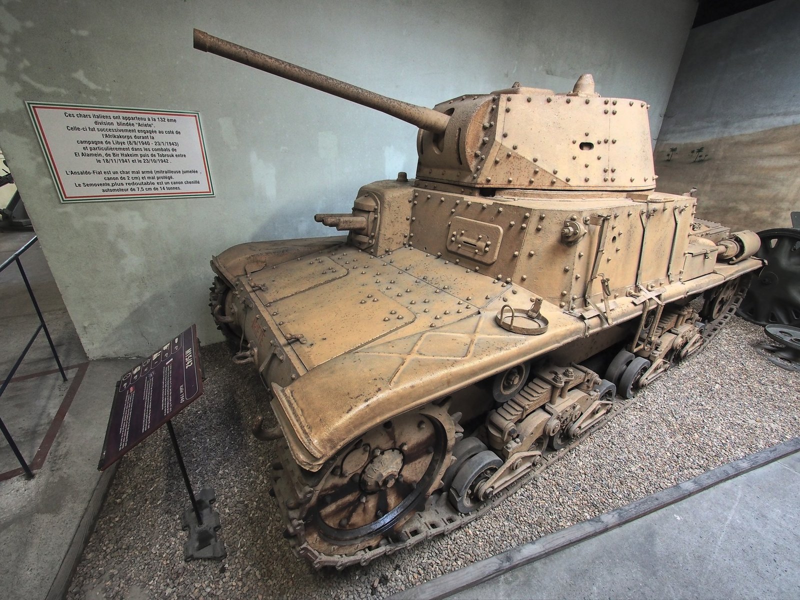 Front-left view of the restored M15/42 at Saumur. The bow twin machine-gun mounting, turret rivets, and mantlet are visible. The display placard describes the type’s service rather than establishing this individual vehicle’s complete history.