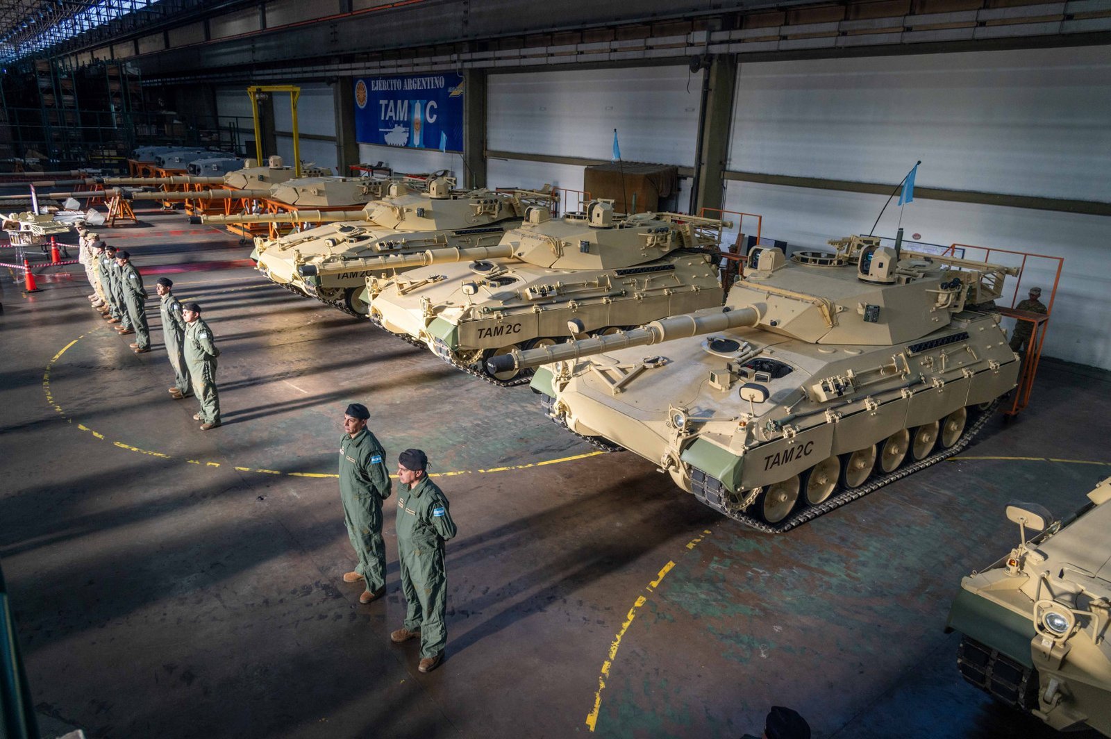 Line of modernized TAM 2C A2 vehicles inside the integration / production facility. July 2024. Batallon de Arsenales 602 / Boulogne Sur Mer. Shows scale, production-line context, and turret fittings.