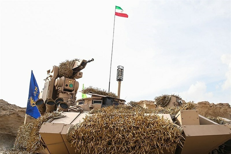 Karrar turret and rear detail during Great Prophet 17. Karrar tank detail view during Great Prophet 17, showing turret fittings, remote weapon station, rear turret cage/slat protection area, and thermal camouflage. 22 December 2021. southern Iran exercise area, exact site not specified. Shows external-layout study; the camouflage cover obscures some armor modules. Source.