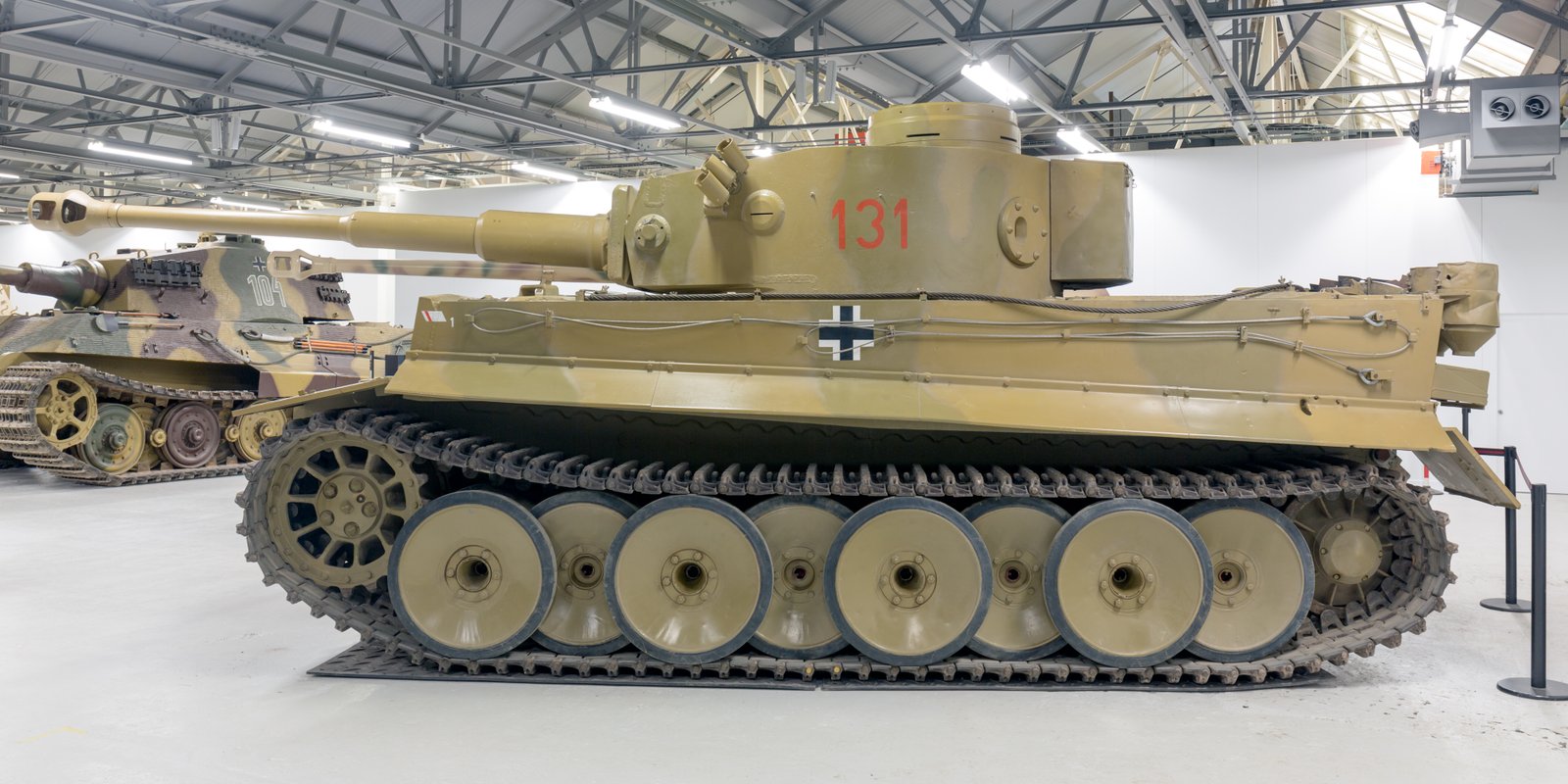 Tiger 131 side view at The Tank Museum, Bovington, 14 March 2017. Bovington, Dorset, United Kingdom. restored museum vehicle, not a wartime field photograph; a Tiger II is visible in the background.