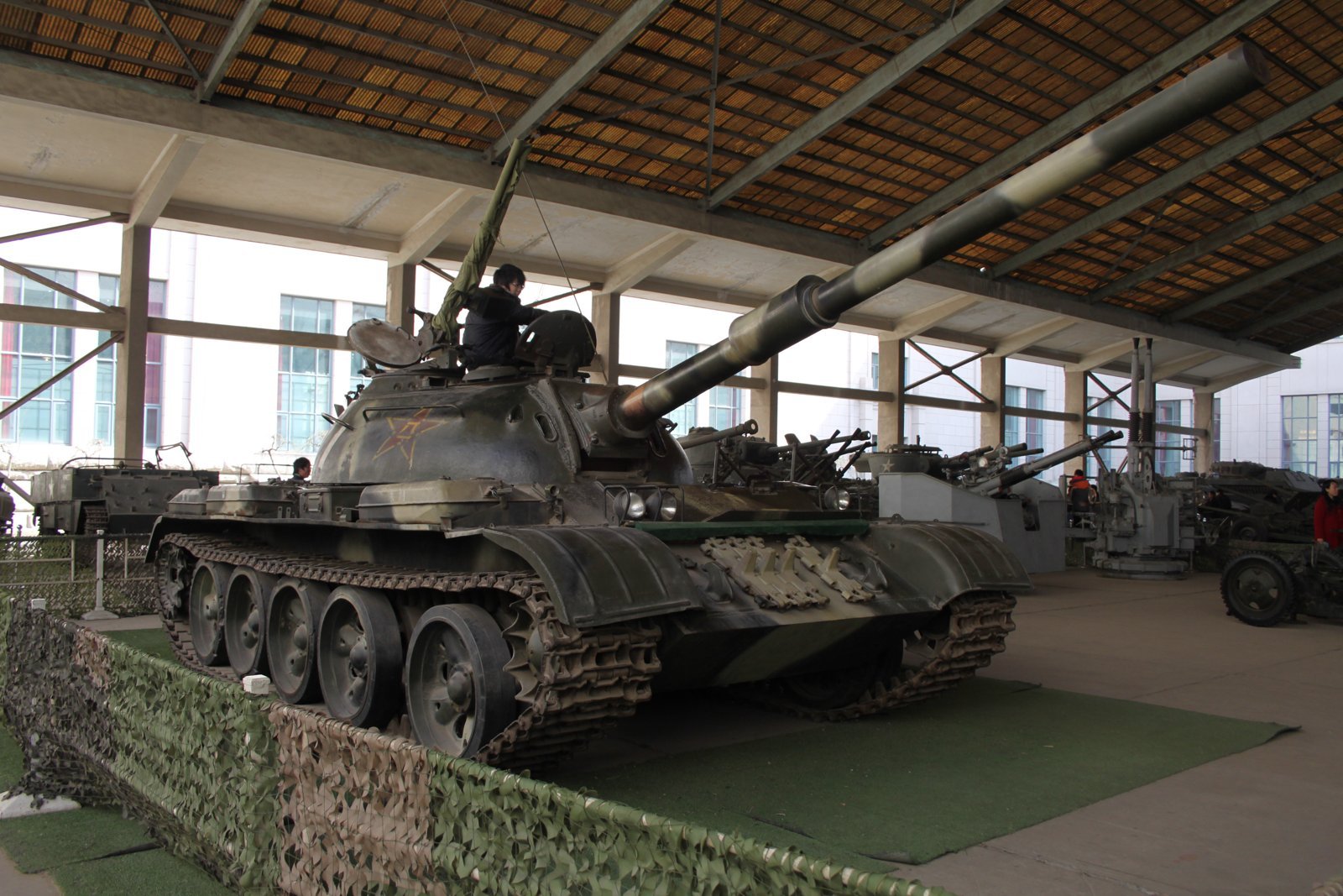 Type 59-II / T-59 tank, front-left view in a museum collection. Vehicle / variant identification: Type 59-II as identified by source page. 13 March 2010, 14:00. source describes “Military Museum: Modern Weapons”; photographer listed from Xinzheng, China. museum-preserved vehicle; source caption does not fully resolve exact museum institution.
